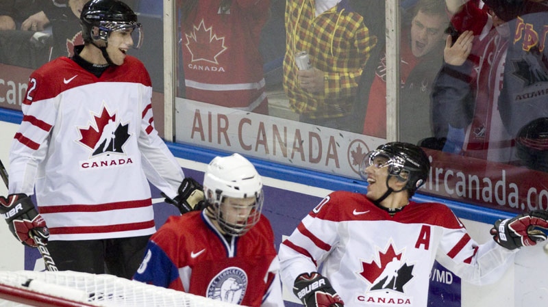 Team Canada forward Brayden Schenn (right) celebrates his 4th goal of the game with teammate Quinton Howden (left) as Team Norway defenceman Adrian Danilesen (8) skates away during third period action at the World Junior Hockey Championships in Buffalo, NY on Wednesday December 29, 2010.(THE CANADIAN PRESS/Frank Gunn)