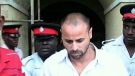 Paul Martin is taken into police custody in Jamaica.