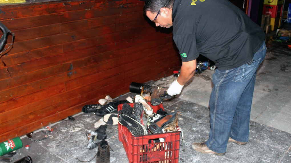Officer inspects victim's belongings after fire