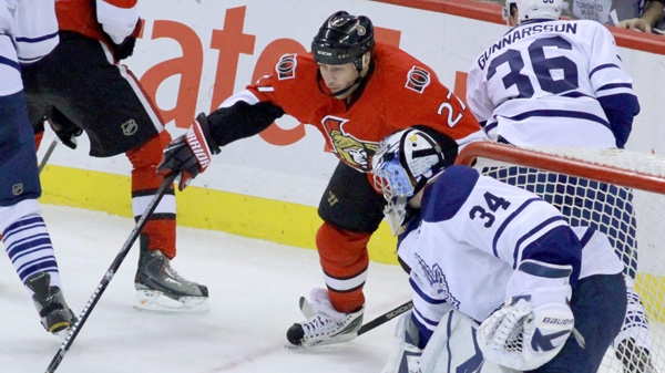 Ottawa Senators' Alex Kovalev (27) attempts to control the puck as Toronto Maple Leafs' Carl Gunnarsson (36) defends and Maple Leafs goaltender James Reimer (34) looks on during second period NHL hockey action in Ottawa Saturday, Jan. 1, 2011. THE CANADIAN PRESS/Fred Chartrand