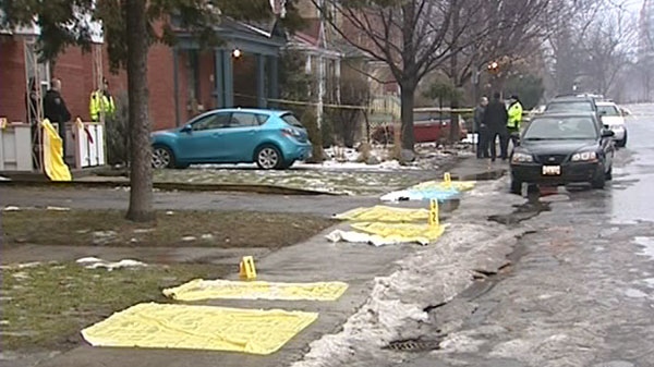 Ottawa police search for clues outside a New Edinburgh home where a man's body was discovered lying in a pool of blood on New Year's Day.