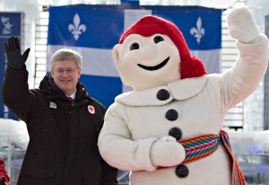 Prime Minister Stephen Harper, flanked by Quebec c