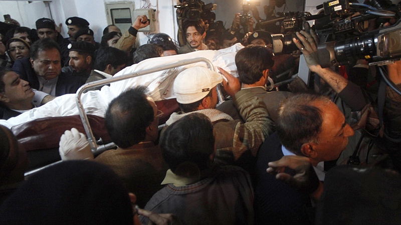People carry dead body of Punjab's governor Salman Taseer who was shot dead by one of his guards, to an ambulance at a local hospital in Islamabad, Pakistan on Tuesday, Jan. 4, 2011. (AP / B.K.Bangash)