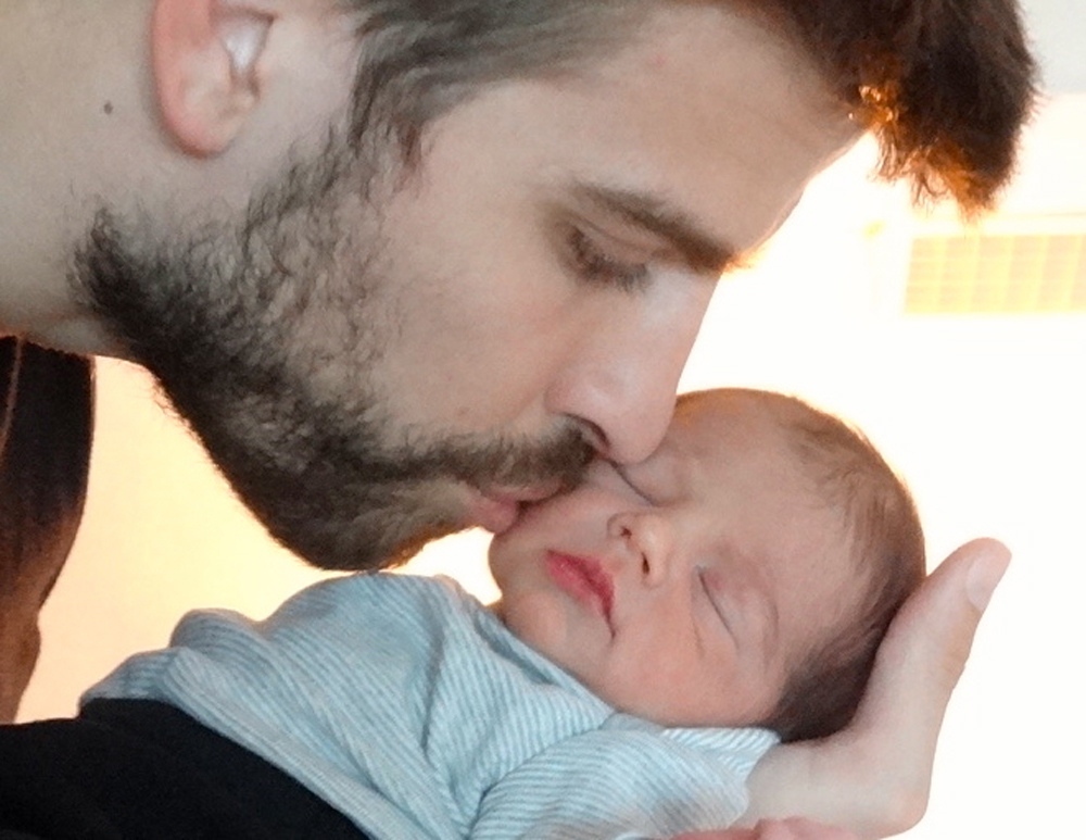 Gerard Piqué kissing his and Shakira's son Milan.