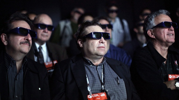 Members of the media wear 3-D glasses as they watch movie clips at the Panasonic 3-D full HD plasma theatre at the International Consumer Electronics Show in Las Vegas in this Jan. 7, 2009 file photo. (The Associated Press / Jae C. Hong)