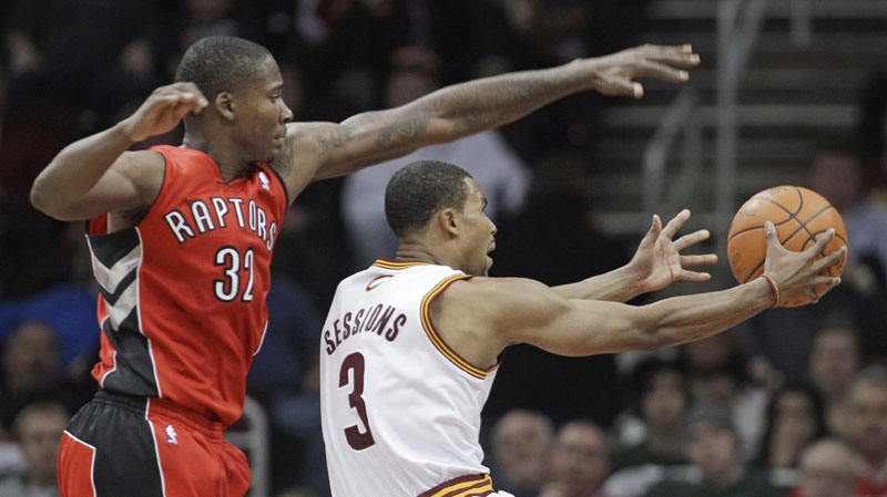 Cleveland Cavaliers' Ramon Sessions (3) tries to shoot around Toronto Raptors' Ed Davis (32) in the fourth quarter of an NBA basketball game Wednesday, Jan. 5, 2011, in Cleveland. The Raptors won 120-105. (AP Photo/Tony Dejak)