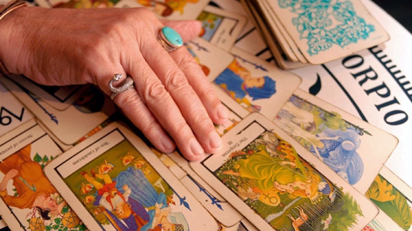 Psychic and Tarot card reader Otis Biggs reads a spread of Tarot cards on Friday, Aug. 10, 2007, in the French Quarter of New Orleans.