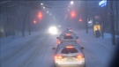 Multiple cars are stopped at red light on a snowy street in Toronto, Friday, Feb. 8, 2013.