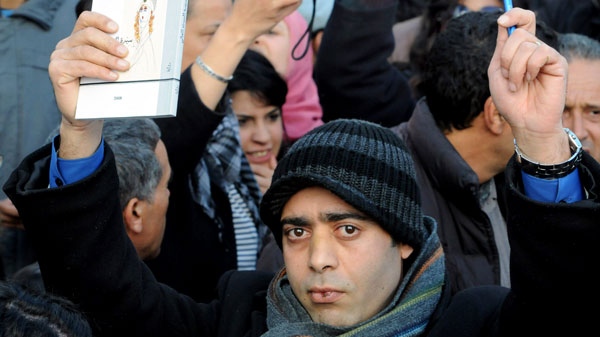 A man holding a pen, asking for freedom of press during a demonstration in Tunis, Tunisia, against high prices and unemployment, Saturday Jan.8, 2011. (AP / Hassene Dridi)