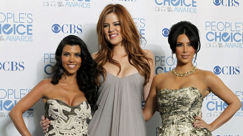 From left, Kourtney Kardashian, Khloe Kardashian, and Kim Kardashian pose for a photo backstage with the award for favorite TV guilty pleasure for "Keeping Up with the Kardashians" at the People's Choice Awards on Wednesday, Jan. 5, 2011, in Los Angeles. (AP Photo/Matt Sayles)
