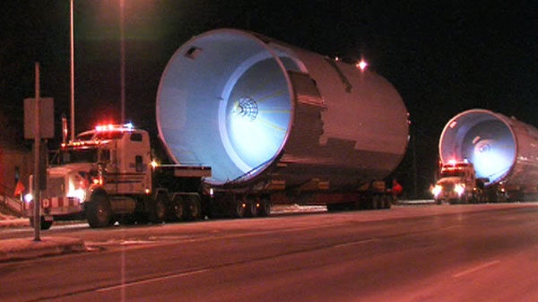 Two trucks in the beer vat convoy on a road in Halton region during the early-morning hours of Monday, Jan. 10, 2011.