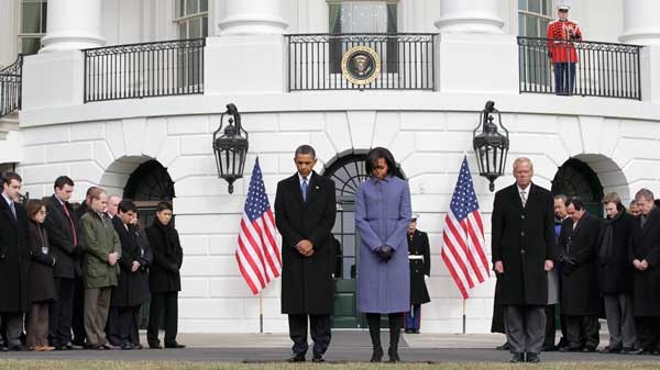 President Barack Obama and first lady Michelle Obama are joined by government employees on the South Lawn of the White House in Washington, Monday, Jan. 10, 2011, to observe a moment of silence for Rep. Gabrielle Giffords, D-Ariz., and the other victims of an assassination attempt against her. (AP Photo / J. Scott Applewhite)