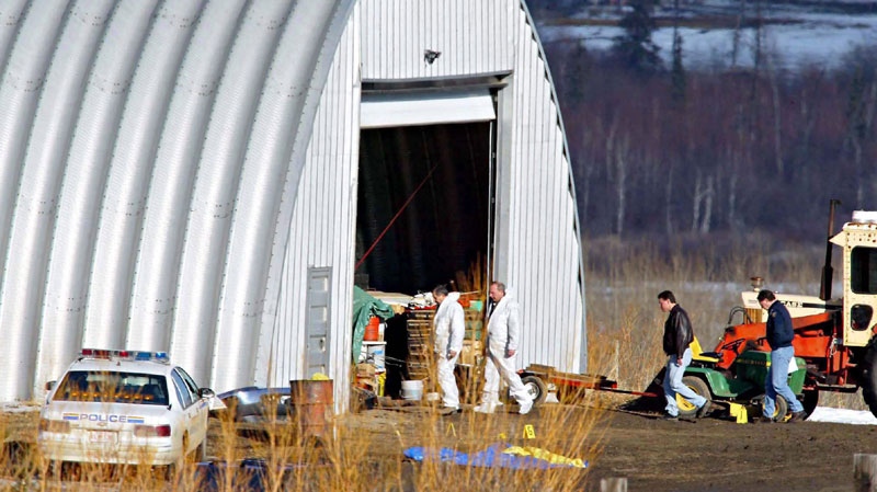 Investigators sort through evidence at the Roszko farm near Mayerthorpe, Alta., Saturday, March 5, 2005. 