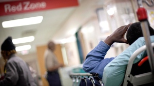 A patient waits along the wall of a hallway in a hospital emergency room in this 2011 photo. (AP / David Goldman)