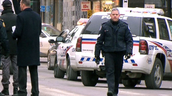 Toronto police Sgt. Ryan Russell (right) on Tuesday, Jan. 11, 2011 at a takedown scene in the city's downtown.