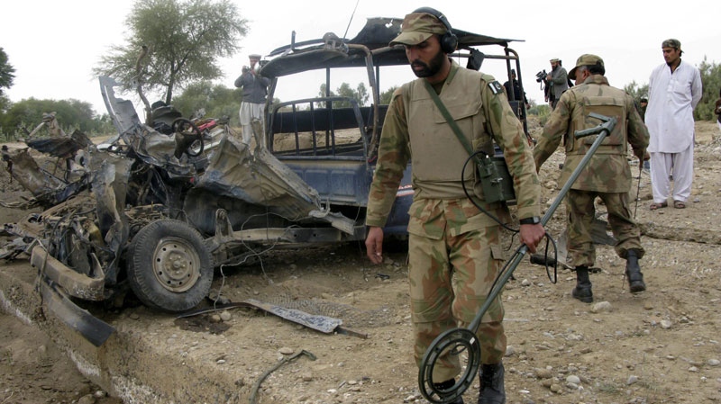 Pakistan army soldiers inspect a police van attacked by suspected militants in Jani Khel, near Bannu, Pakistan, Thursday, Jan. 13, 2011. (AP Photo/Ijaz Muhammad)
