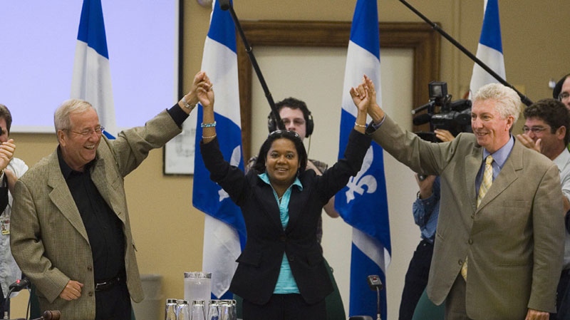 Newly-elected Bloc Quebecois Member of Parliament Eve-Mary Thai Thi Lac (centre) receives a standing ovation from Bloc Quebecois leader Gilles Duceppe (right) and caucus chairman Louis Plamondon (left) at the start of a caucus meeting on Parliament Hill in Ottawa Wednesday, September 26, 2007. (THE CANADIAN PRESS/Fred Chartrand)