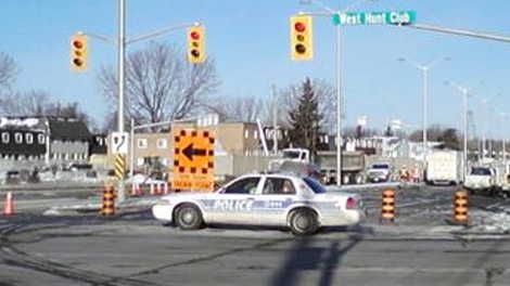 Police close Woodroffe Avenue to block off a giant hole caused by a broken water main, Friday, Jan. 14, 2011.