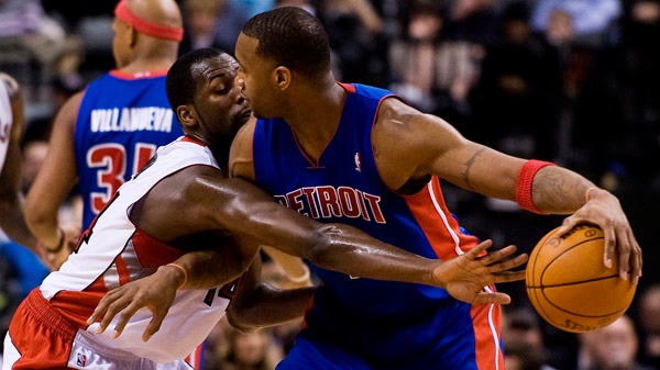 Toronto Raptors forward Julian Wight tries to steal the ball from Detroit Pistons' Tracy McGrady during second half play in Toronto on Friday, January 14, 2011. THE CANADIAN PRESS/Aaron Vincent Elkaim