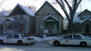 Cruisers and police tape surround a home on Redwood Avenue Saturday morning.