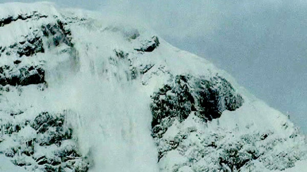 Heavy snow falling off the side of a mountain is seen in this file photo taken from video, Fernie, B.C. 