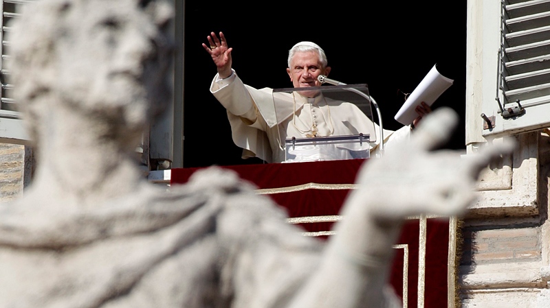 Pope Benedict XVI waves at faithful at the end of the Angelus prayer from his studio window overlooking St. Peter's Square at the Vatican, Sunday, Jan. 16, 2011. (AP / Pier Paolo Cito)