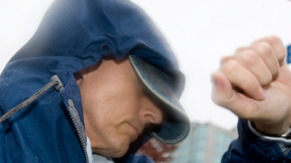 Orville Mader, convicted of sex crimes against young boys in Asia, tries to block photographers from taking his picture after making an appearance in provincial court in Abbortsford, B.C. Monday, December 3, 2007. (THE CANADIAN PRESS / Jonathan Hayward)