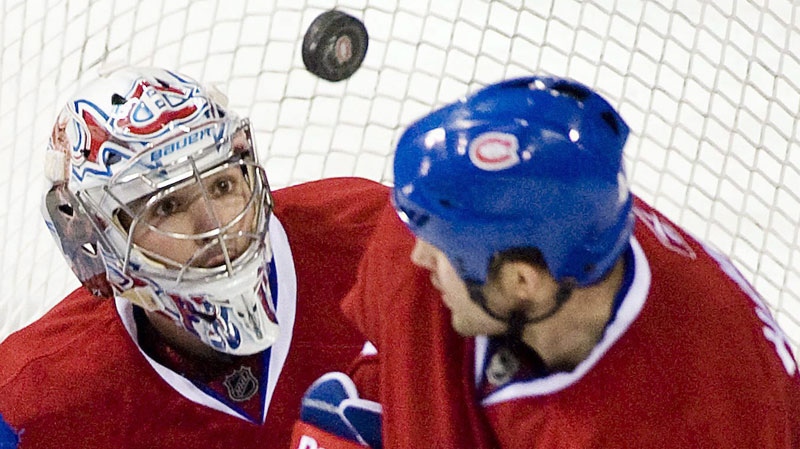 Montreal Canadiens goaltender Carey Price, left, keeps his eyes on the puck as Canadiens' Roman Hamrlik defends during third period of an NHL hockey game against the New York Rangers in Montreal, Saturday, January 15, 2011. (THE CANADIAN PRESS/Graham Hughes)