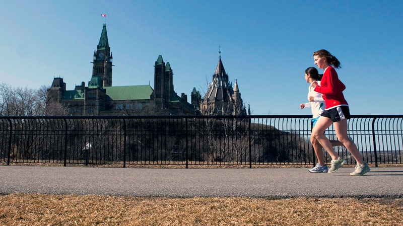 Joggers make their way through Majors Hill Park in downtown Ottawa in view of Parliament Hill on Wednesday, March 17, 2010. (Sean Kilpatrick / THE CANADIAN PRESS)
