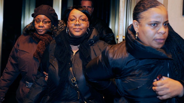 Joy White, centre, birth mother of Carlina White, exits a hotel with two unidentified women in New York, Thursday, Jan. 20, 2011. (AP / Stephen Chernin)