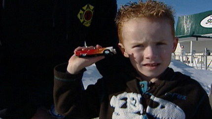 Aiden Scott shows off a toy car he was given from SO-CAL Speed Shop for his bravery.