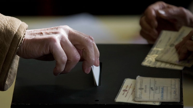 A voter casts his ballot in Portugal's presidential election Sunday, Jan. 23 2011, at a polling station in Lisbon. (AP / Armando Franca)