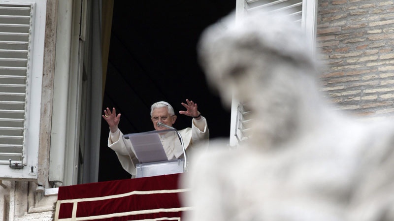 Pope Benedict XVI greets the faithful during the Angelus prayer from his studio window overlooking St. Peter's Square at the Vatican, Sunday, Jan. 23, 2011. (AP Photo/Pier Paolo Cito)