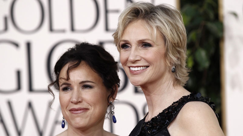Jane Lynch and Lara Embry, left, arrive at the Golden Globe Awards Sunday, Jan. 16, 2011, in Beverly Hills, Calif. (AP Photo/Matt Sayles)