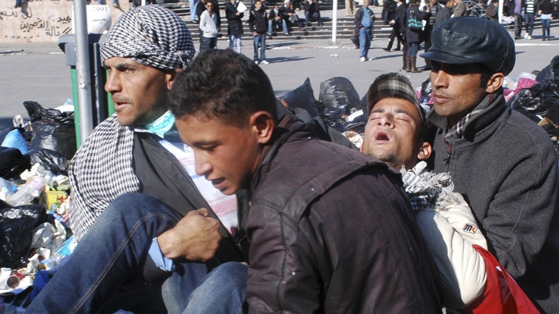 Wounded protesters are evacuated after clashes in Tunis, Wednesday, Jan. 26, 2011. (AP / Salah Habibi)