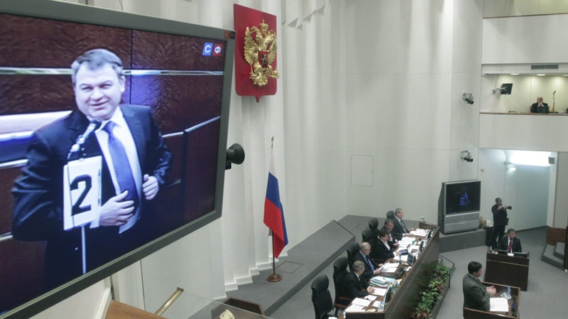 Russian Defense Minister Anatoly Serdyukov is seen on a screen after voting at Russia's Federation Council, the upper house of parliament, in Moscow, Russia, Wednesday, Jan. 26, 2011. (AP Photo/Mikhail Metzel)