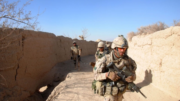 Canadian soldiers move through the village of Khenjakak in southern Afghanistan on Tuesday Jan. 4, 2011, as they search for weapons hidden by insurgents. (THE CANADIAN PRESS/ Steve Rennie)