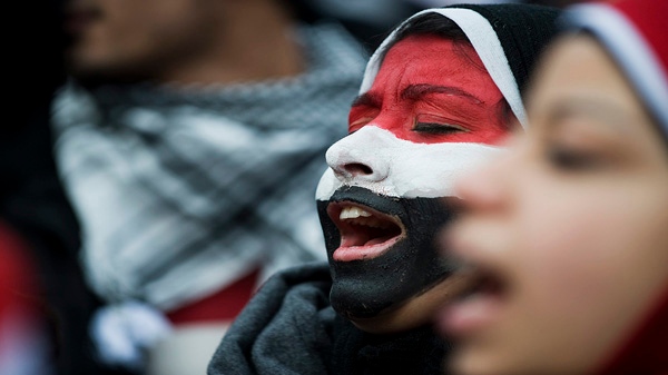 A girl with her face painted the colours of the Egyptian flag protests at Dundas Square in Toronto to support protests in Egypt against President Hosni Mubarak on Saturday, Jan. 29, 2011. (THE CANADIAN PRESS/Aaron Vincent Elkaim)