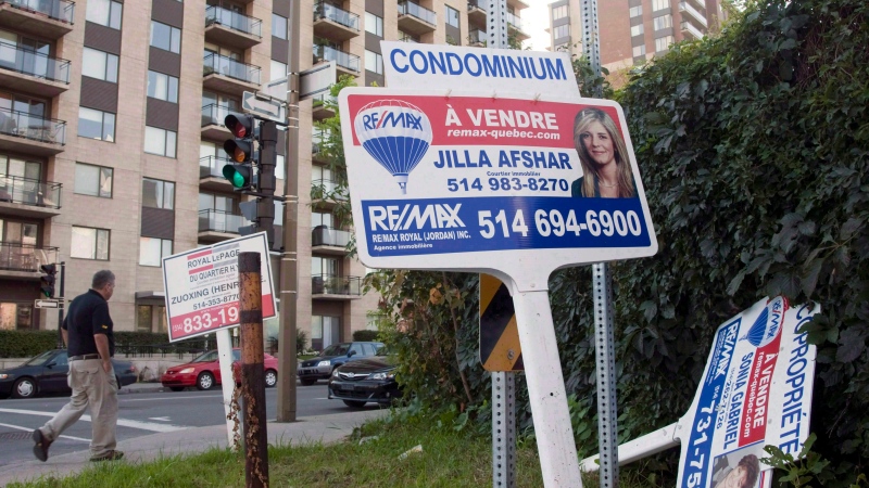 For sale signs stand in front of a condominium in Montreal in 2011 file photo. (Ryan Remiorz/ THE CANADIAN PRESS)