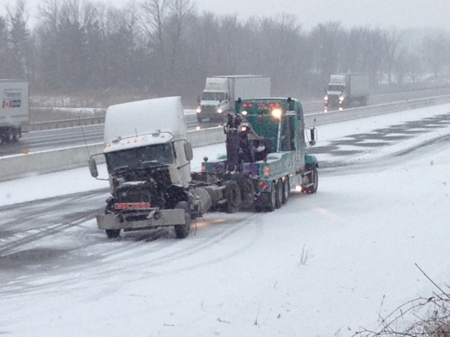 A damaged cab is towed away from the site of a crash on Highway 401 near Drumbo, Ont., on Wednesday, March 13, 2013. (Kevin Doerr / CTV Kitchener)