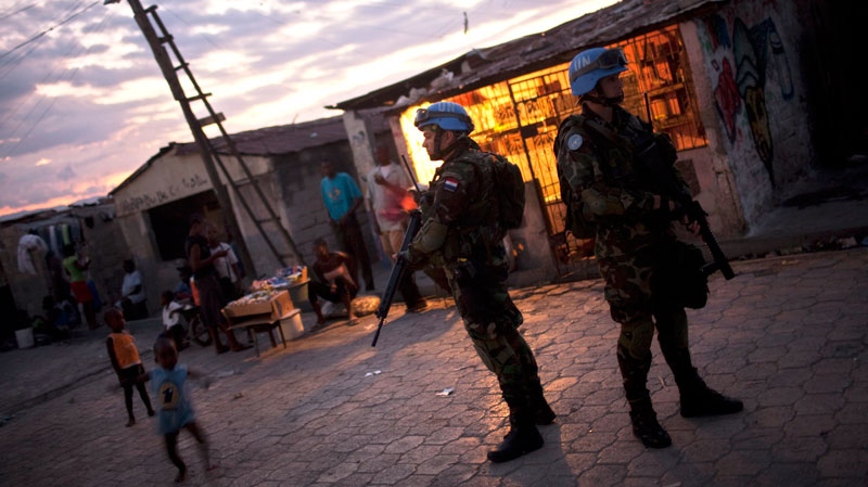 UN peacekeepers from Paraguay stand guard at the slum of Cite Soleil, in Port-au-Prince, Haiti, Wednesday, Feb. 2, 2011. (AP / Rodrigo Abd)