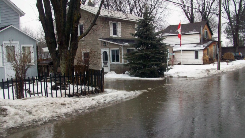Water from the thaw and rain flooded Old George St. in Osgoode.