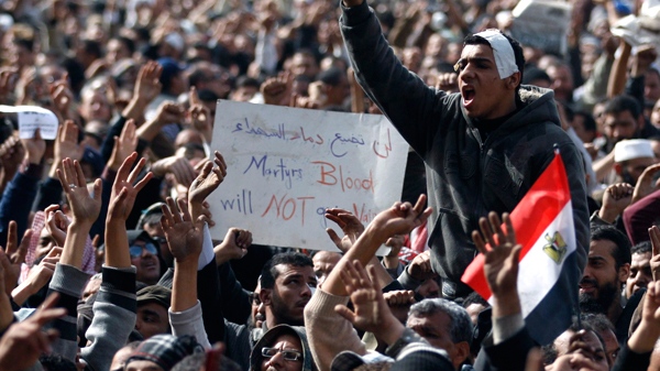 Anti-government protesters react in Tahrir Square, Cairo, Egypt, Friday, Feb. 4, 2011. (AP / Khalil Hamra)