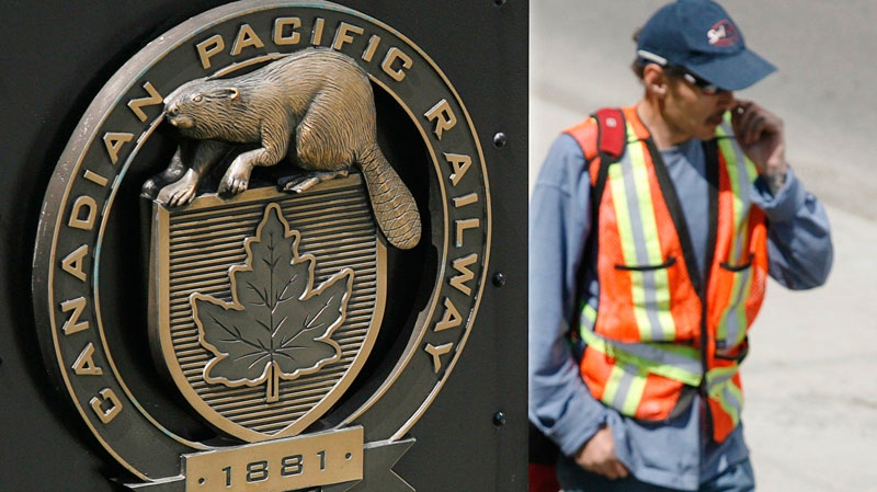 A construction worker walks past the Canadian Pacific Railway headquarters in Calgary, May 16, 2007. (Jeff McIntosh / THE CANADIAN PRESS)