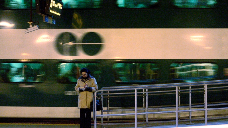 A woman reads a book as a GO commuter train pulls away from the platform at Toronto's Union Station, March 4, 2008. (J.P. Moczulski / THE CANADIAN PRESS)