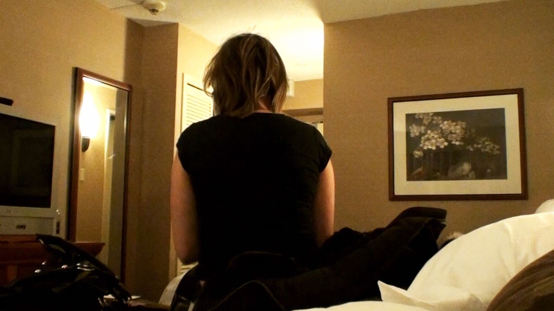 An 18-year-old sex worker speaks with Det.-Const. Leanne Marchen, not shown, in a downtown Toronto hotel room.