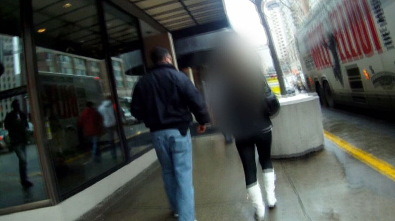 Det.-Const. Steve Wolfe walks with a sex worker outside a downtown Toronto hotel.