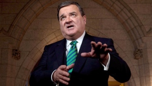  Finance Minister Jim Flaherty takes part in a TV interview after tabling the federal budget in the House of Commons on Parliament Hill in Ottawa on Thursday March 21, 2013. (Adrian Wyld / THE CANADIAN PRESS) 