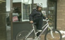 Katie Brown gets on her bike outside a store in Stratford, Ont., on Friday, March 22, 2013. (CTV Kitchener)