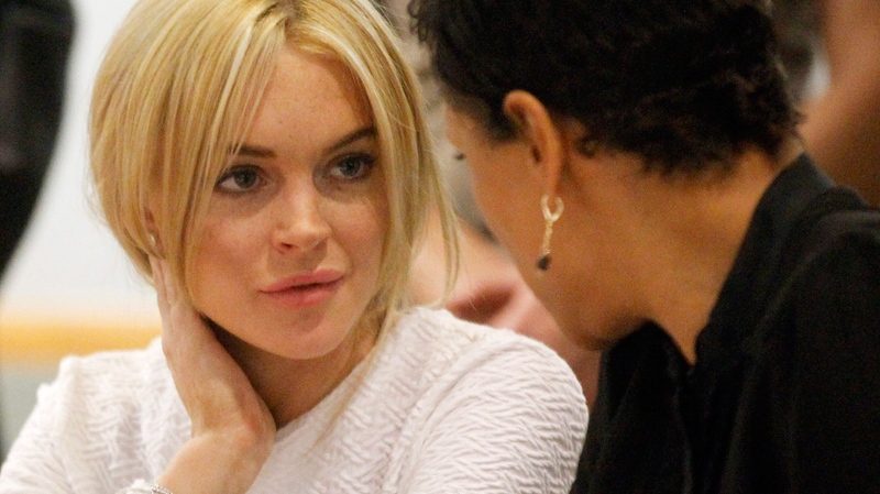 Lindsay Lohan appears in court during her arraignment on a felony grand theft charge with her lawyer Shawn Chapman Holley at the LAX Airport Courthouse in Los Angeles, Wednesday, Feb. 9, 2011. (AP / Mario Anzuoni)